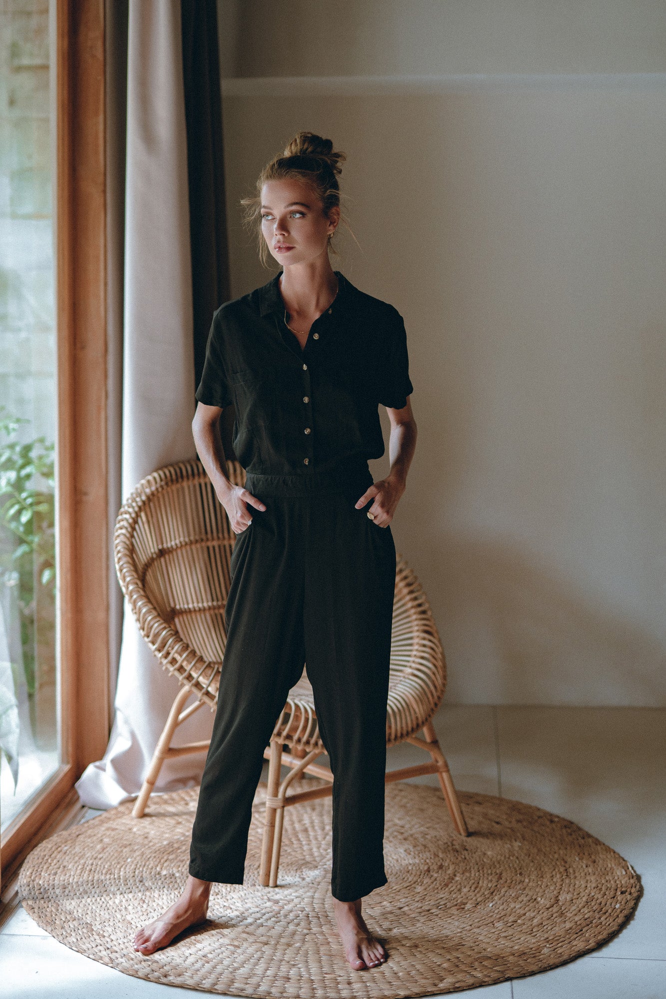 woman rocking a black jumpsuit made for those early spring days